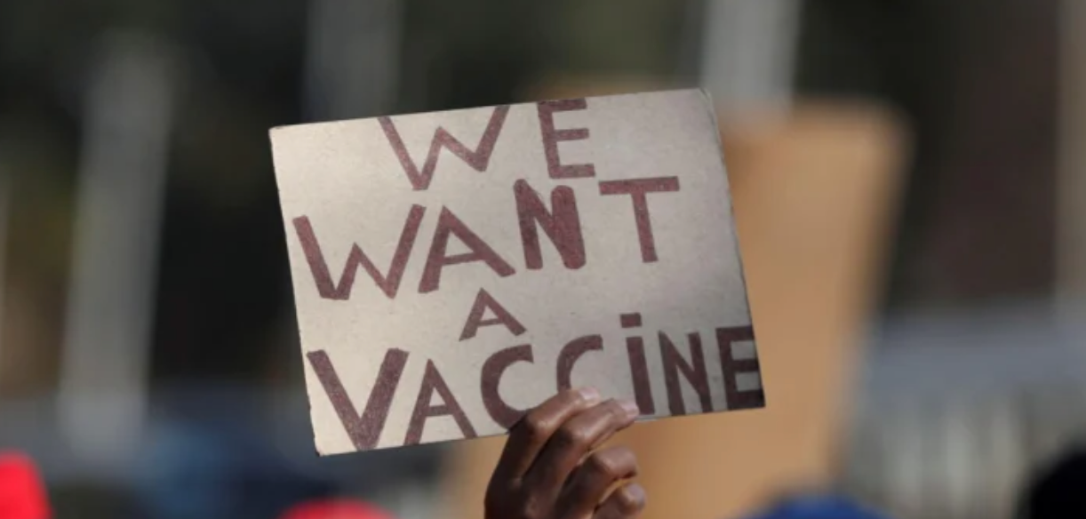 A person holds a placard during a march to demand a COVID-19 vaccine rollout in Pretoria, South Africa. Photo by: Siphiwe Sibeko / Reuters